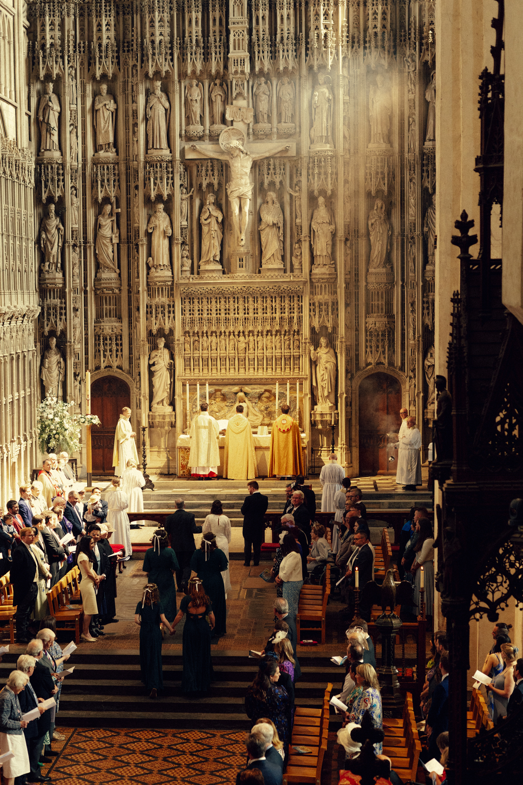 A & J Wedding 6 Cinematic shot of bride walking down aisle with father towards groom in St Albans cathedral