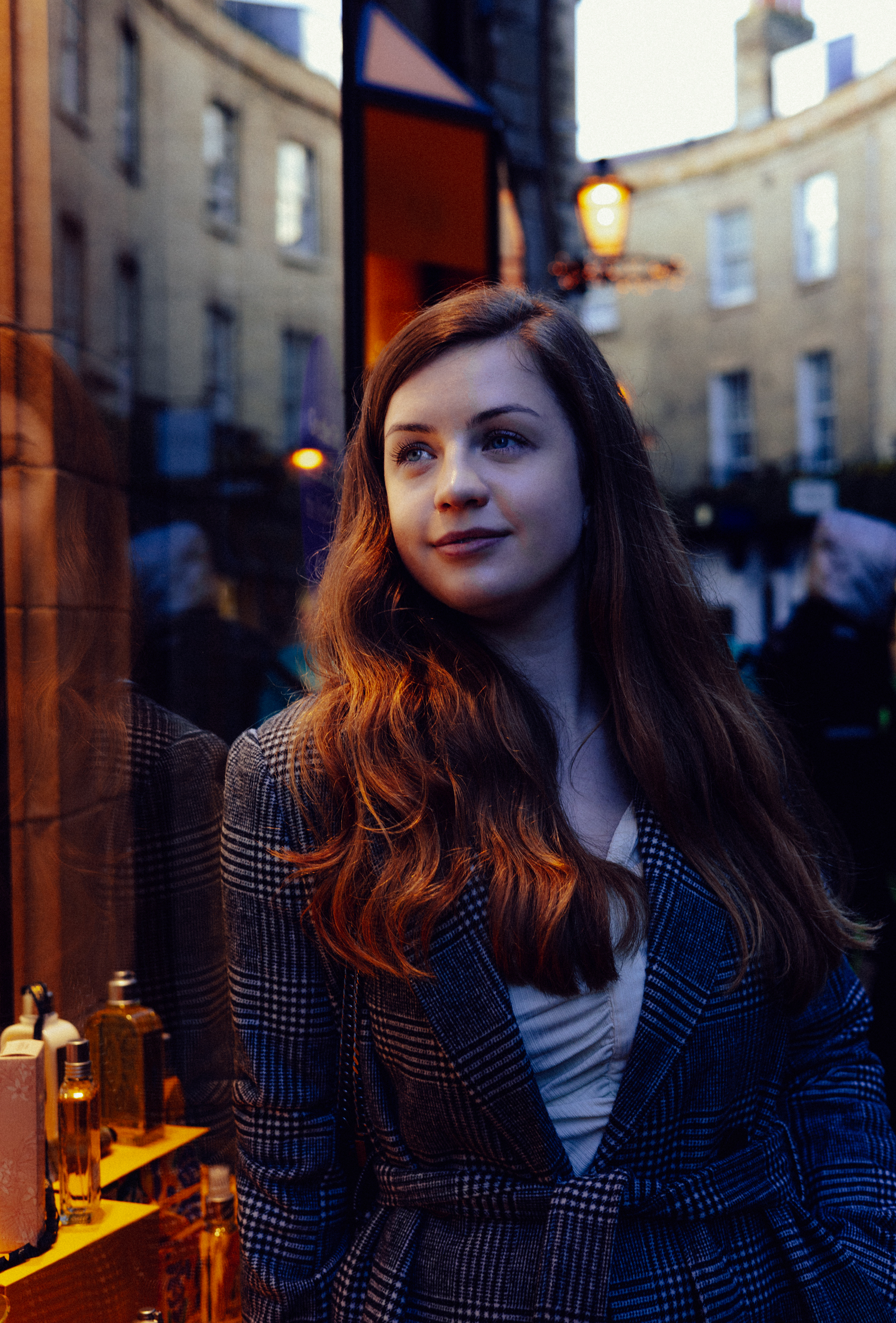 Danielle 16 woman leaning against shop window under lamplight