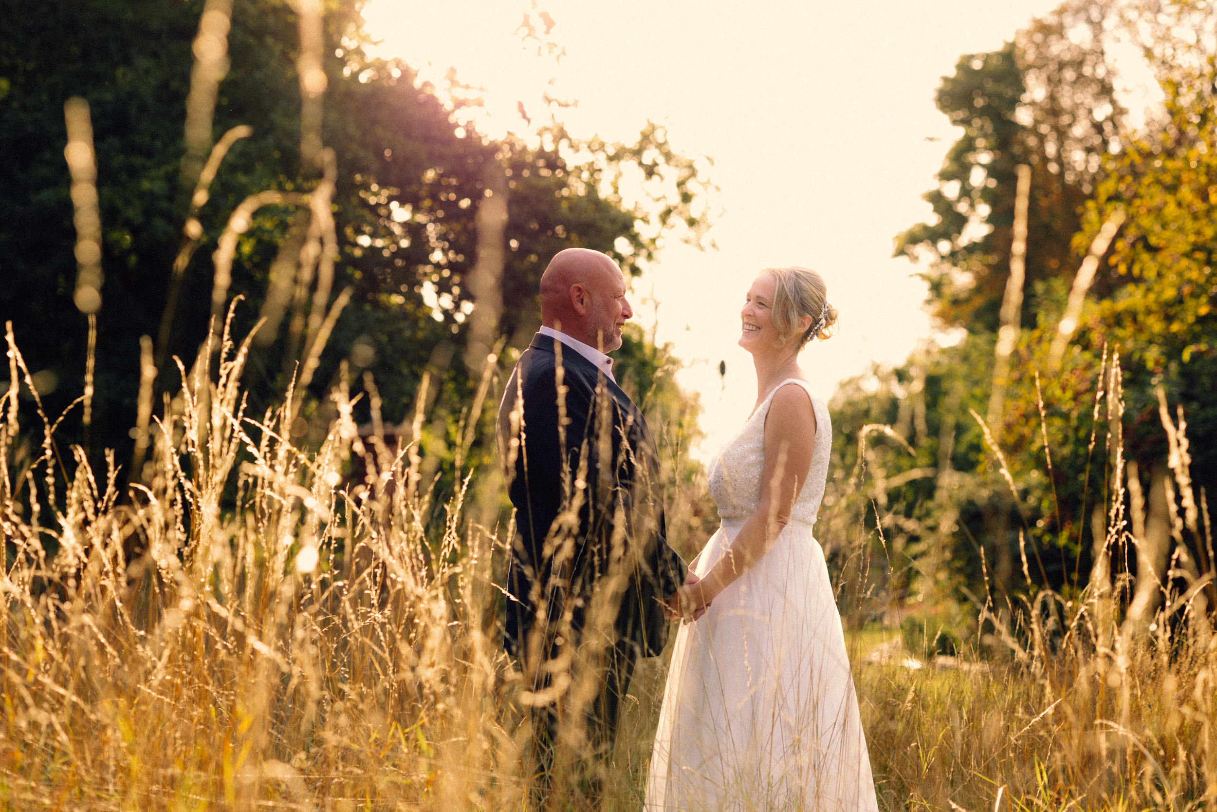 couple portrait in field at sunset 